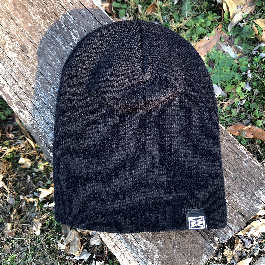 Black ribbed knit beanie with logo tag