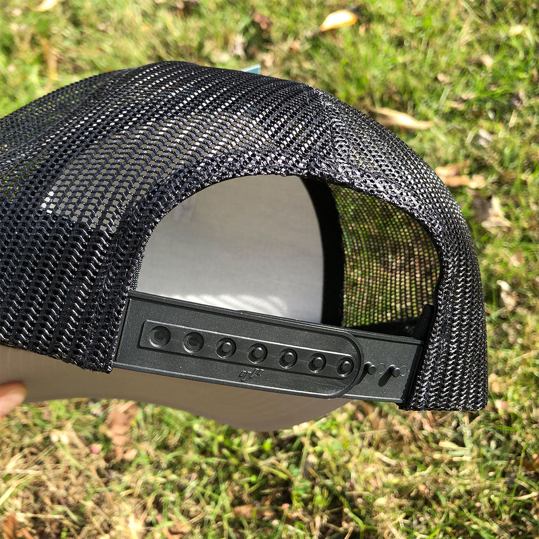 RIZNWILD “Storm” heather grey and black trucker hat with bold lightning bolt logo. Snapback mesh cap built for everyday streetwear and outdoor lifestyle.