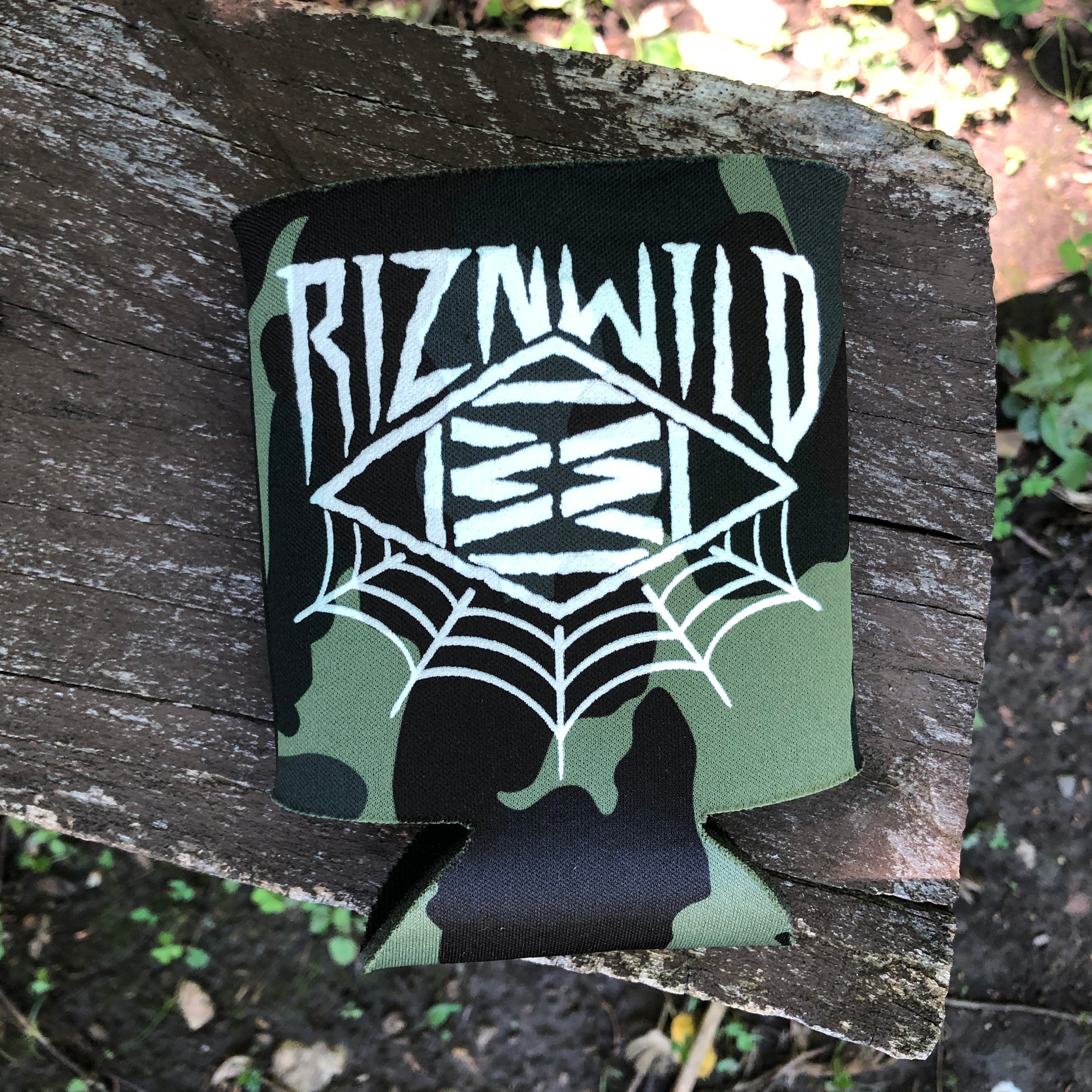 Koozie with 'Riznwild' logo on a wooden surface