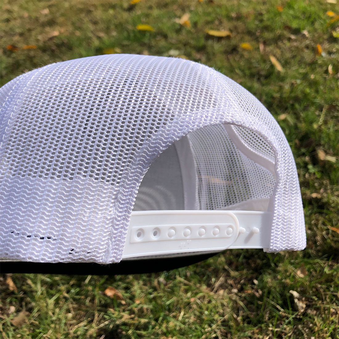 lack and white RIZNWILD Legend flat bill trucker hat