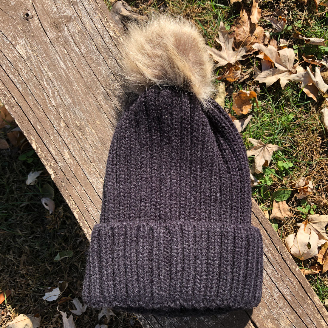 Black RIZNWILD faux fur pom beanie cuffed back view