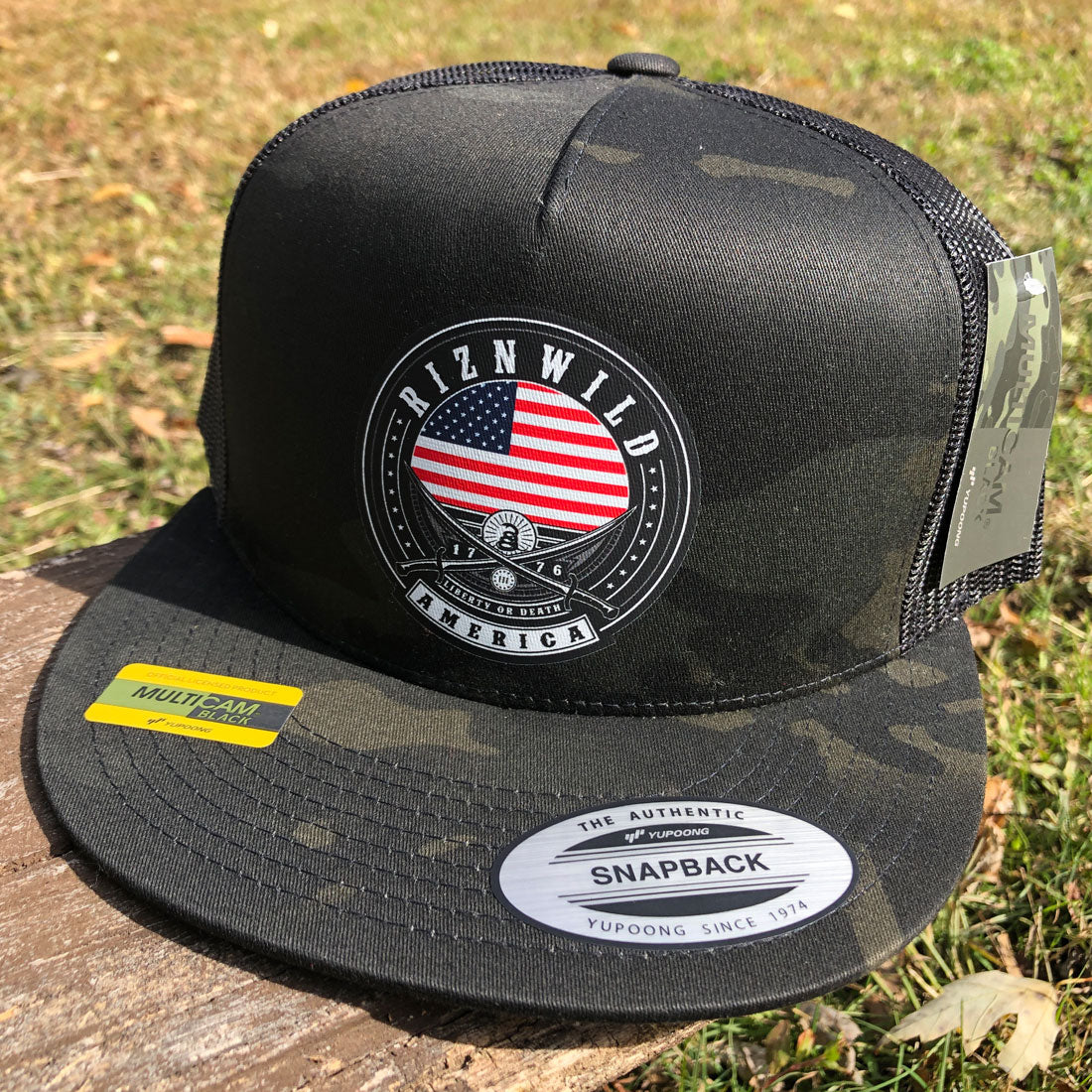 RIZNWILD Liberty Trucker Hat in MultiCam Black with American flag patch on front panel