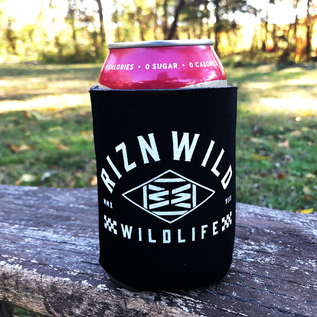 Front view of black RIZNWILD drink sleeve showing bold white adventure logo.