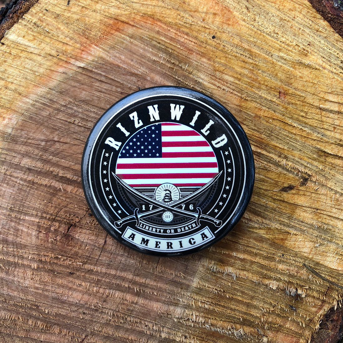 RIZNWILD America 250th anniversary button with American flag, 1776 date, Liberty or Death banner, and crossed blades displayed