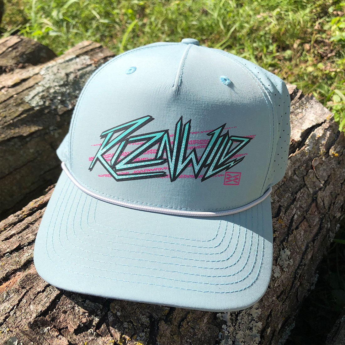 A light blue baseball cap with a stylized 'RIZNWILD' graphic in teal and pink on the front.