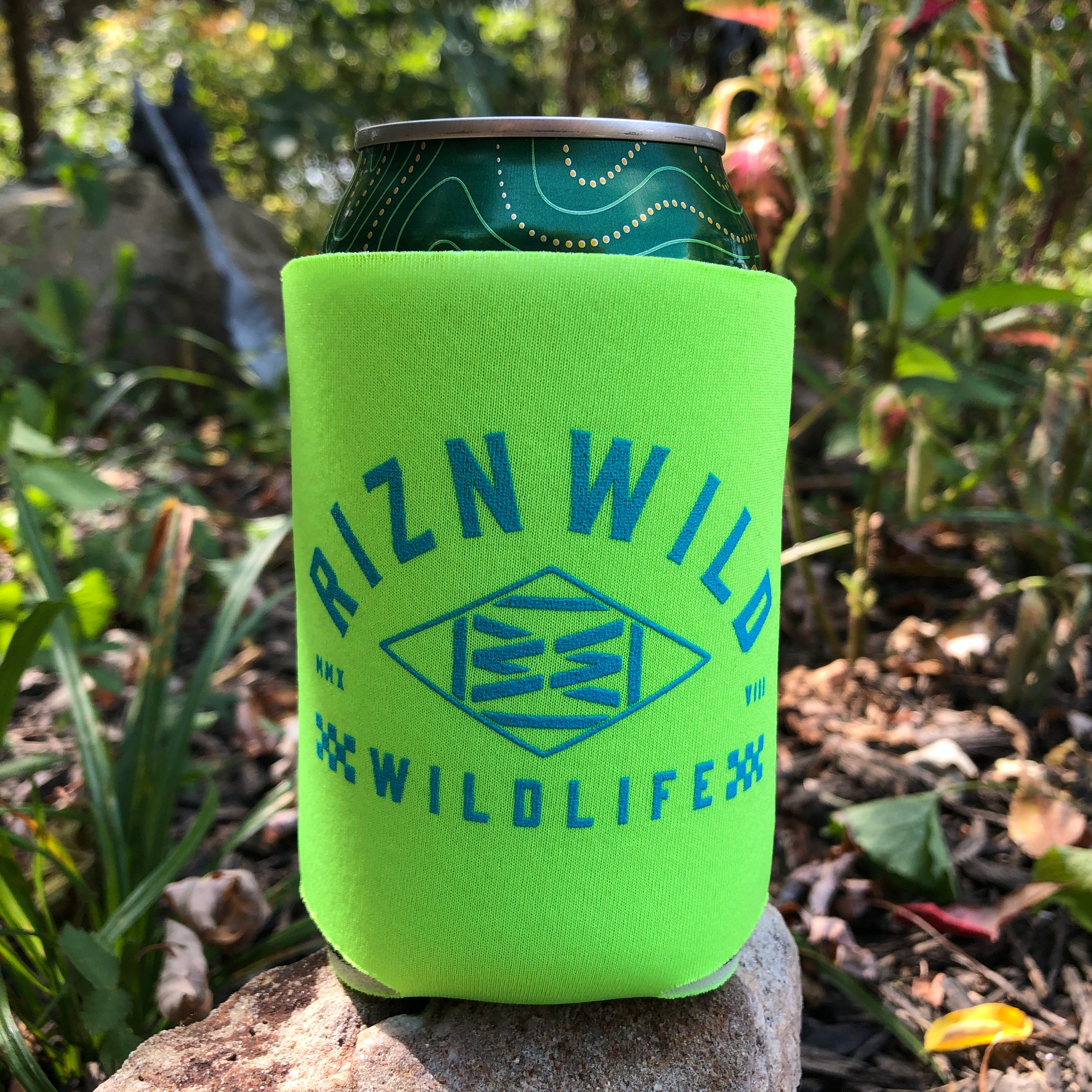RIZNWILD Wildlife neon drink koozie holding a canned drink in an outdoor setting