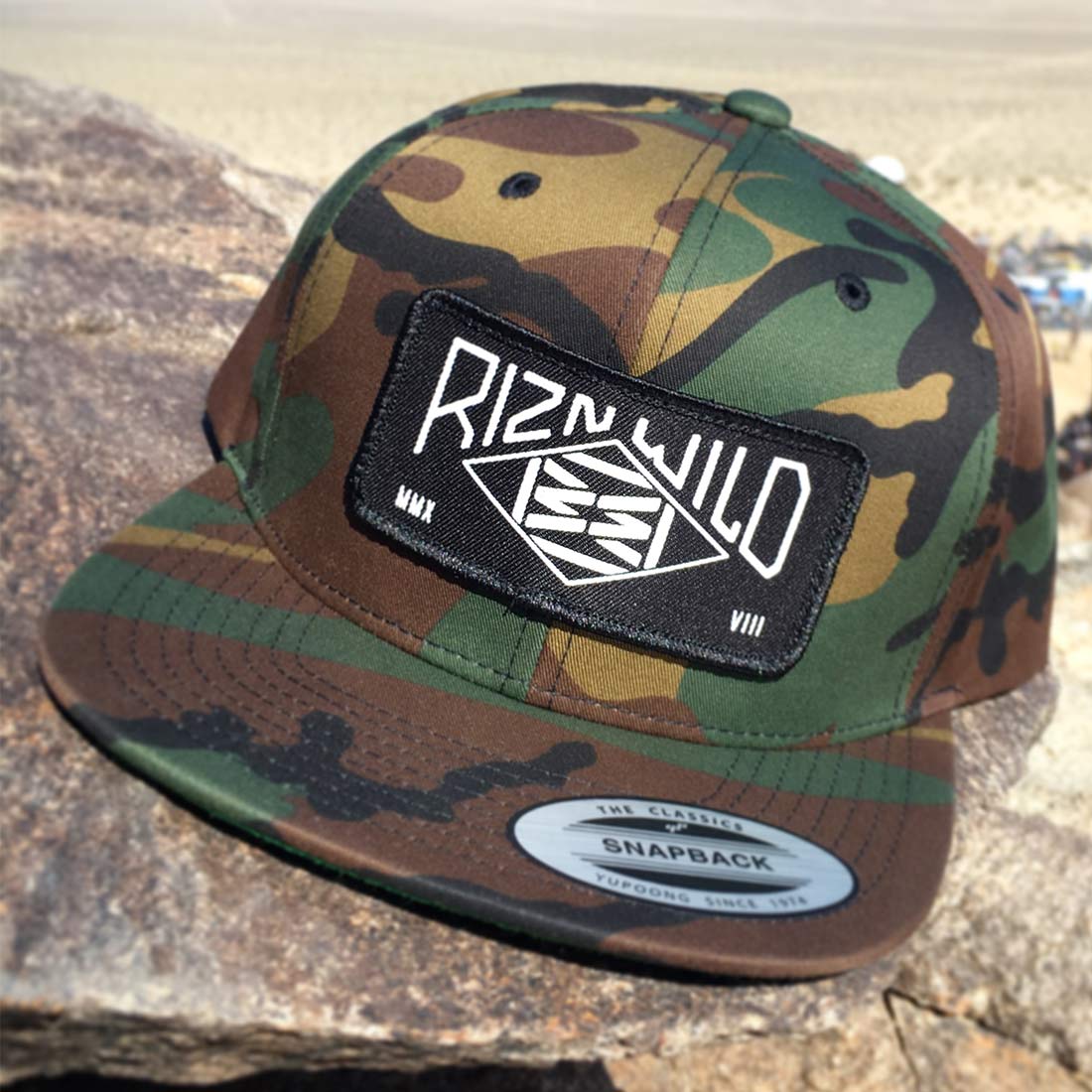 RIZNWILD | Range Camo hat sitting on rock